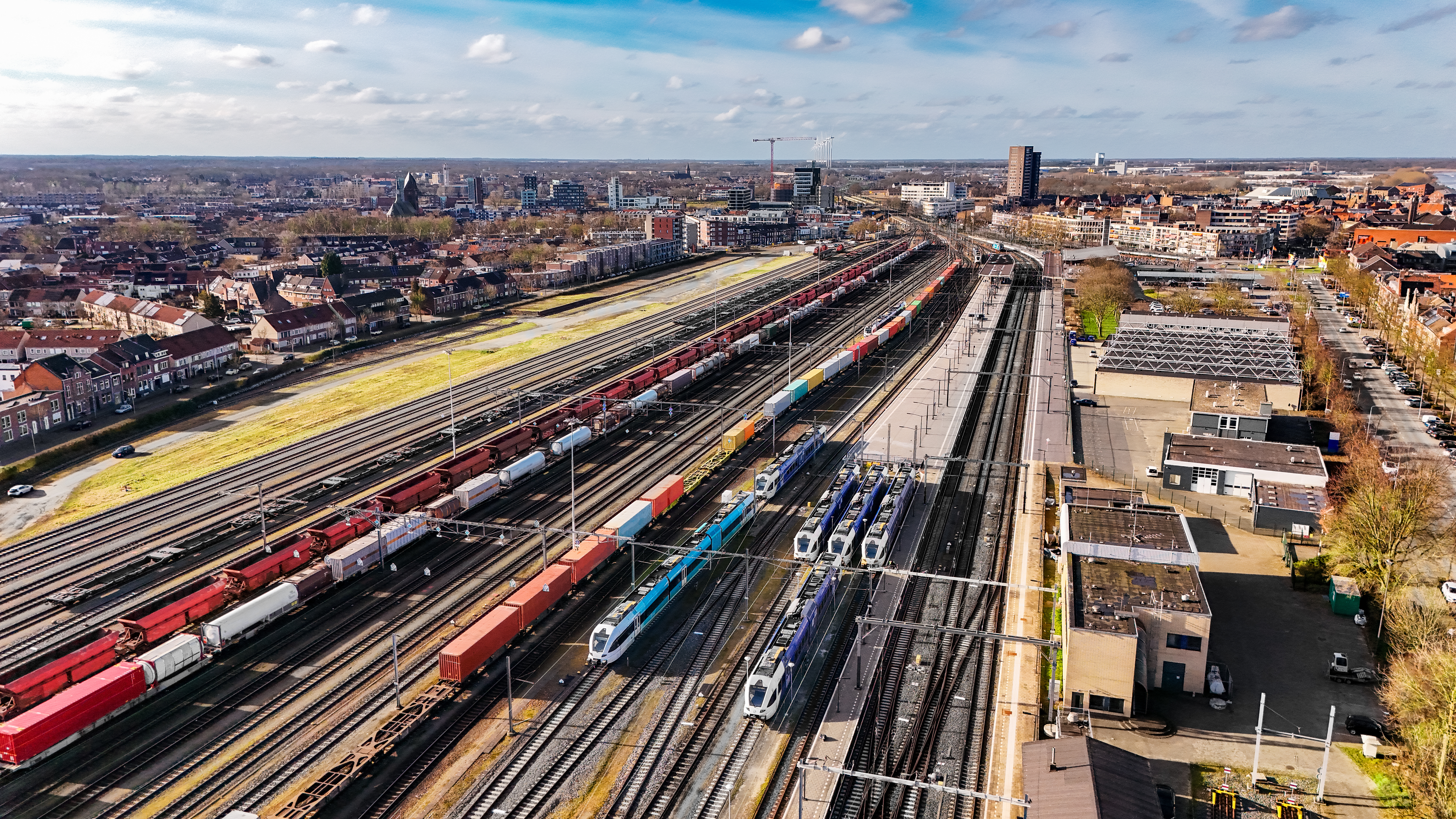 Railroad, train tracks and trains aerial drone view from above, railway station in the Netherlands, transportation, logistics and public transport infrastructure concept